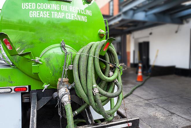 a service truck pumping grease from a restaurant's grease trap in Amston